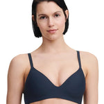 Model wearing the Passionata Pila Wirefree T-Shirt Bra in Sailing Blue with a plunging neckline and smooth, molded cups for a seamless everyday fit.