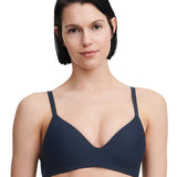 Model wearing the Passionata Pila Wirefree T-Shirt Bra in Sailing Blue with a plunging neckline and smooth, molded cups for a seamless everyday fit.