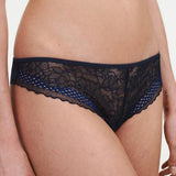Model wearing the Pila Tanga Brief in Sailing Blue, showcasing its floral lace front with scalloped edge and soft waistband fit.