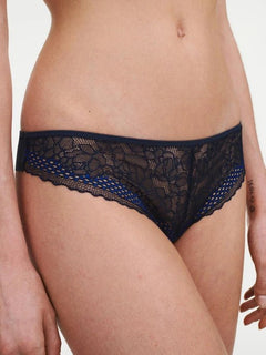 Model wearing the Pila Tanga Brief in Sailing Blue, showcasing its floral lace front with scalloped edge and soft waistband fit.