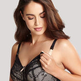 Woman wearing Panache Sophie Maternity Bra Black/Chai, adjusting drop-down nursing cup, soft lace and cotton-lined.