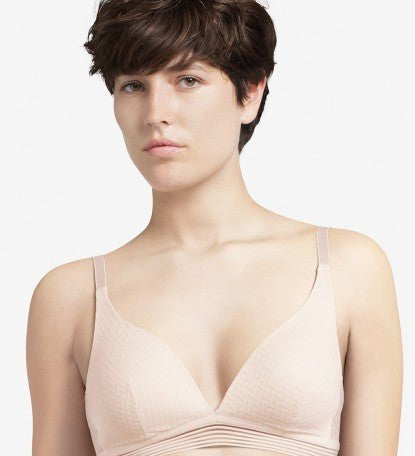 Model wearing the Manhattan Non Wire Triangle Bra in Talc with lightly padded cups and graphic tulle finish.