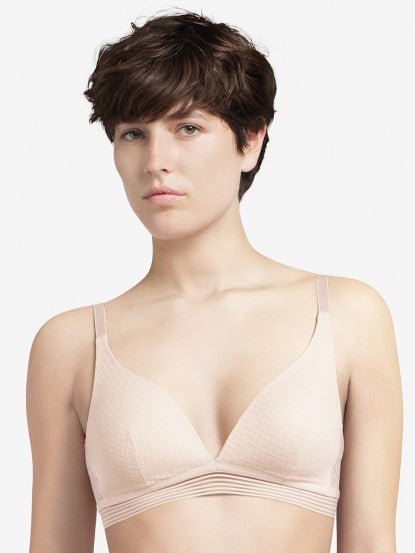 Model wearing the Manhattan Non Wire Triangle Bra in Talc with lightly padded cups and graphic tulle finish.