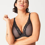 Model in Passionata Brooklyn Plunge T-Shirt Bra in Black from The Foundation, with low centre plunge, foam underwire cups, and smooth lace detail. front view