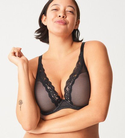 Model in Passionata Brooklyn Plunge T-Shirt Bra in Black from The Foundation, with low centre plunge, foam underwire cups, and smooth lace detail. front view