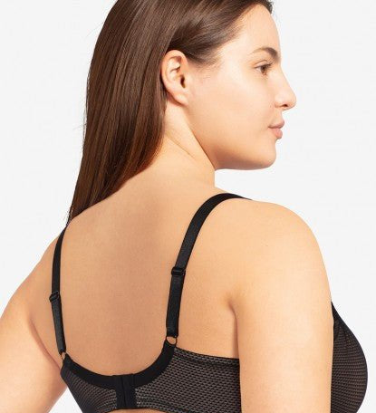 Model in Passionata Brooklyn Plunge T-Shirt Bra in Black from The Foundation, with low centre plunge, foam underwire cups, and smooth lace detail. back view
