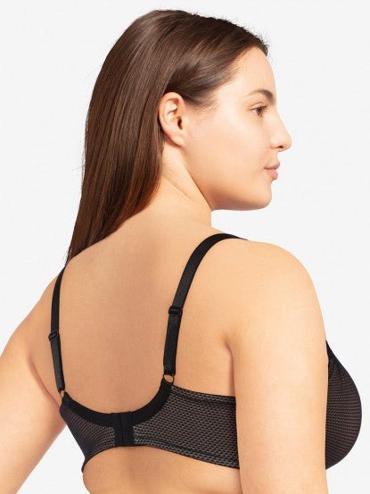 Model in Passionata Brooklyn Plunge T-Shirt Bra in Black from The Foundation, with low centre plunge, foam underwire cups, and smooth lace detail. back view
