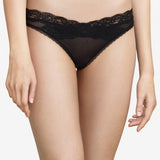 Model wearing Passionata Brooklyn Tanga Brief in Black from The Foundation, designed with sheer mesh, flat lace, and a seamless low-rise fit. front view