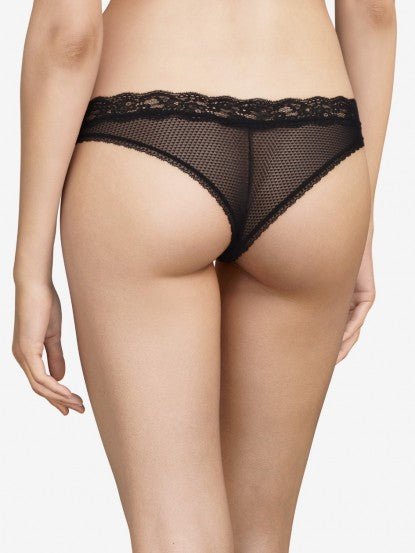 Model wearing Passionata Brooklyn Tanga Brief in Black from The Foundation, designed with sheer mesh, flat lace, and a seamless low-rise fit. back view