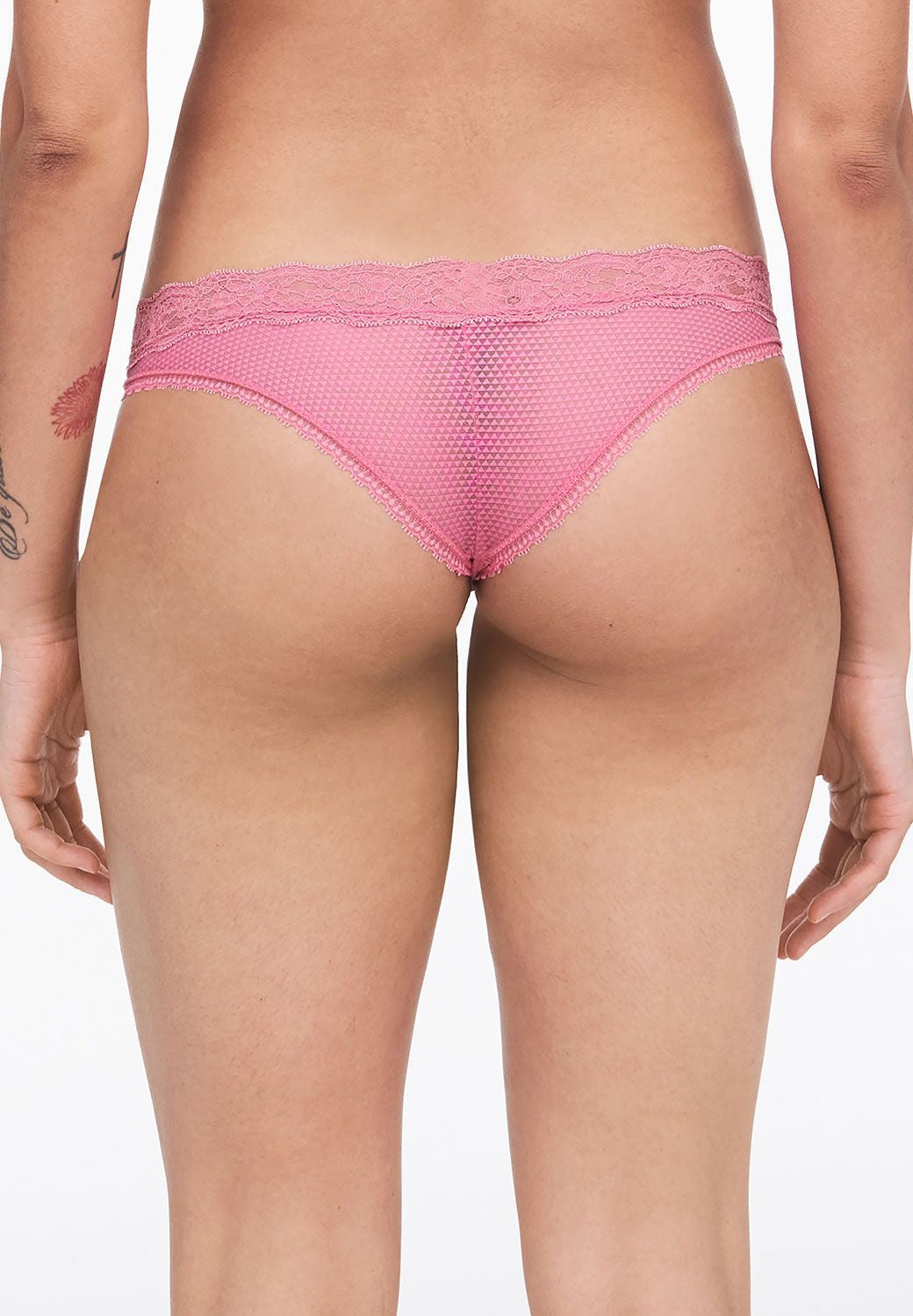 back view of Model wearing the Brooklyn Tanga Brief Gardenia from The Foundation – sheer mesh and seamless lace for a no-VPL finish.