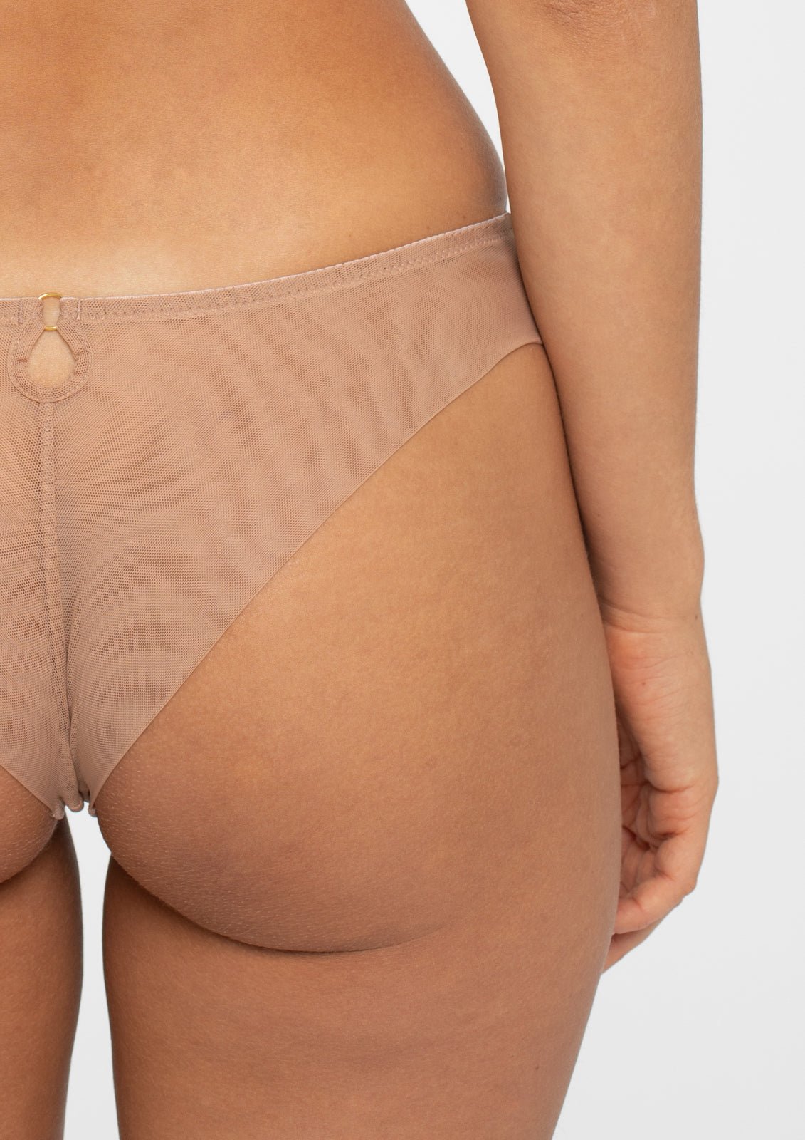 Back view of the Samanta Perla Thong in cappuccino, showing mesh rear and seamless finish, available at The Foundation.