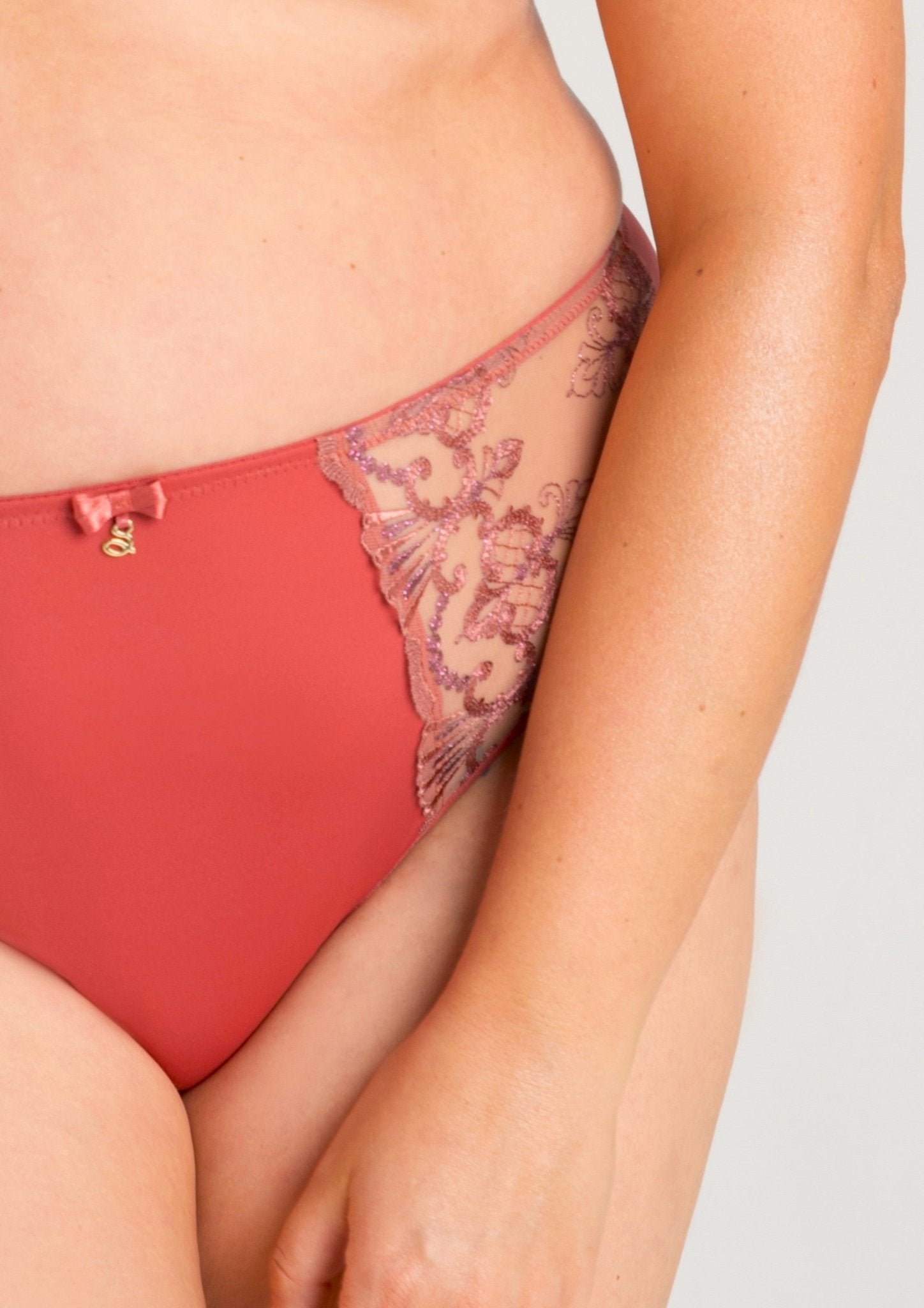 Close up of model wearing Samanta’s Perla Midi Brief in Rosy, lace detail on hips—available at The Foundation Australia.
