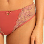 Close up of Model wearing Perla Thong in Rosy showing lace sides and subtly raised waist.