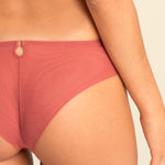 Back view of model wearing Perla Thong showcasing mesh rear and seamless cut.