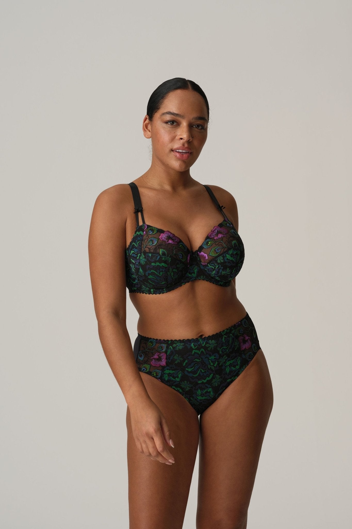 Model standing in Prima Donna San Angel Full Brief Peacock Feather, paired with matching bra, highlighting colourful lace from The Foundation.