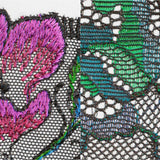Zoomed embroidery of San Angel Peacock Feather plunge bra, highlighting intricate pink and teal feather threadwork, exclusive to The Foundation.