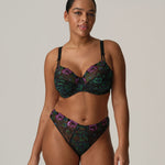 Model in San Angel Thong Brief Peacock Feather by Prima Donna, styled with matching bra, showing blue-green Italian lace at The Foundation.