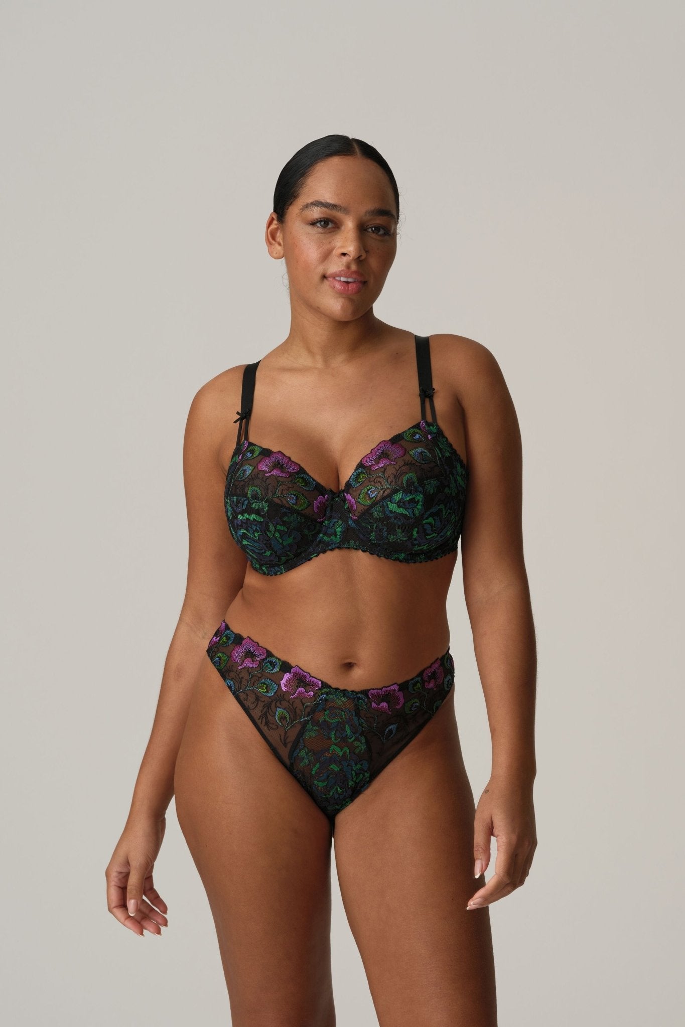 Model in San Angel Thong Brief Peacock Feather by Prima Donna, styled with matching bra, showing blue-green Italian lace at The Foundation.