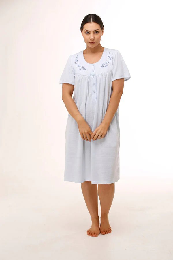 Model wearing Schrank Embroidered Short Sleeve Nightie Blue, front view, showing soft jersey knit and pretty embroidery, available at The Foundation.