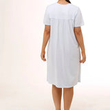 Back view of Schrank Embroidered Short Sleeve Nightie Blue, model showing soft gathering and short length, featured at The Foundation.