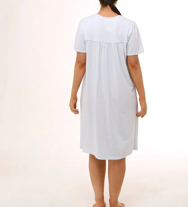 Back view of Schrank Embroidered Short Sleeve Nightie Blue, model showing soft gathering and short length, featured at The Foundation.