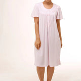 Model wearing Schrank Embroidered Short Sleeve Nightie Pink, front view, showcasing soft jersey knit fabric and delicate embroidery, available at The Foundation.