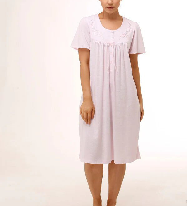 Model wearing Schrank Embroidered Short Sleeve Nightie Pink, front view, showcasing soft jersey knit fabric and delicate embroidery, available at The Foundation.