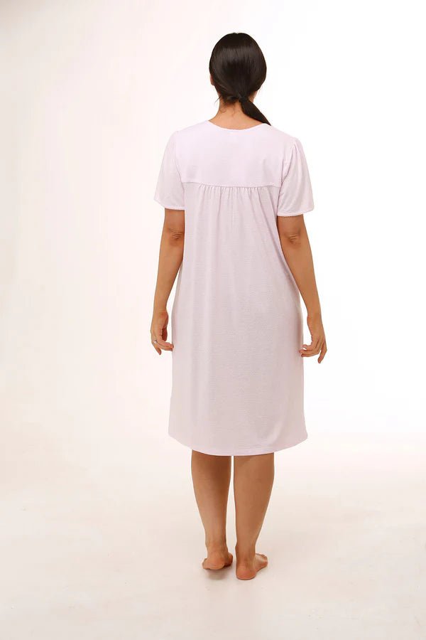 Back view of Schrank Embroidered Short Sleeve Nightie Pink, model showing soft gathering detail and short length, featured at The Foundation.
