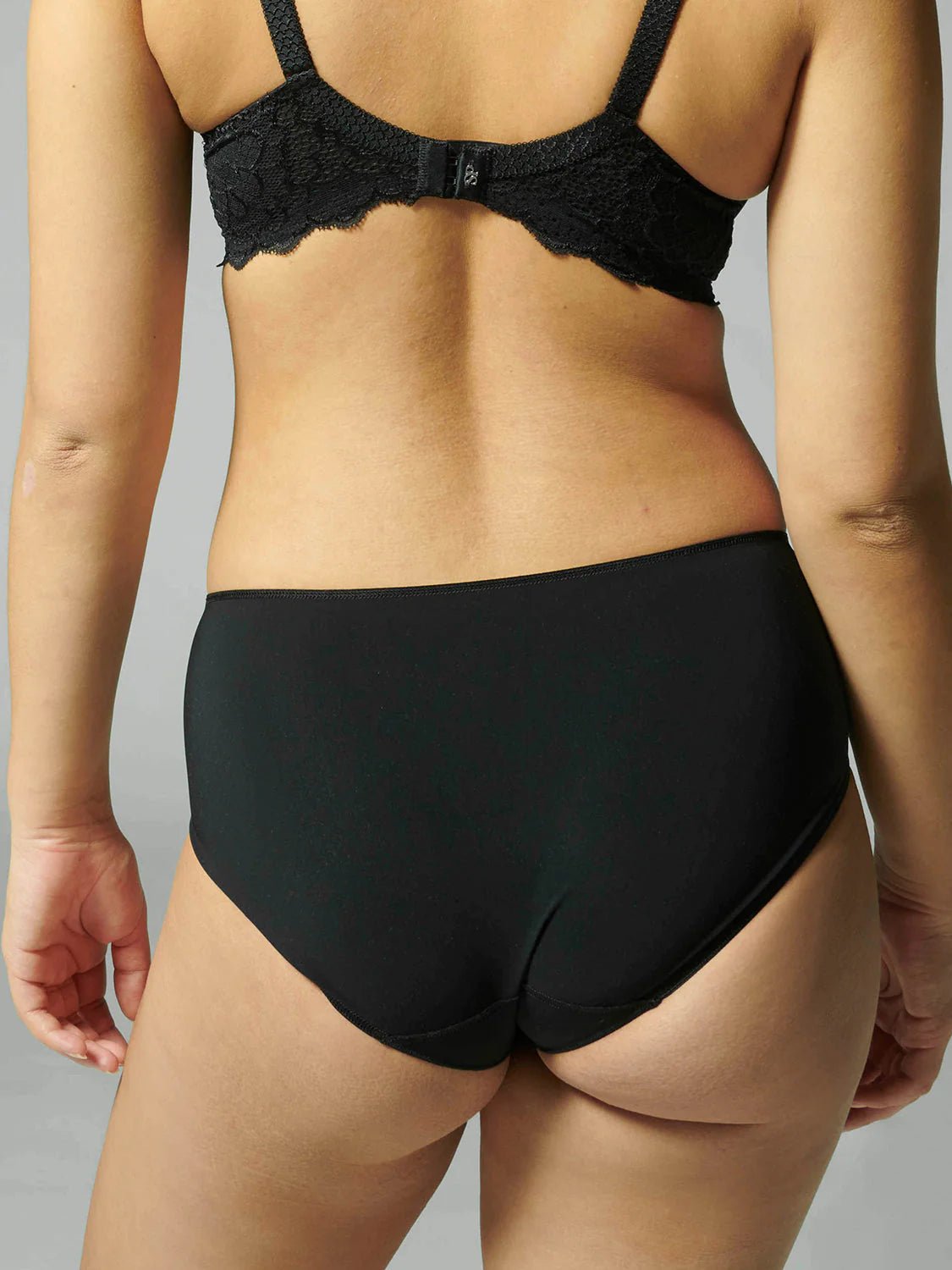 Back view of the Caresse Brief in Black, highlighting smoothing microfibre back and full coverage fit.