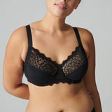 Model wearing Simone Pérèle Caresse Full Cup Bra in Black from The Foundation, featuring 3-part supportive cups, lace finish, and cotton lining. close up