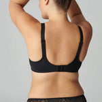 Model wearing Simone Pérèle Caresse Full Cup Bra in Black from The Foundation, featuring 3-part supportive cups, lace finish, and cotton lining. back view