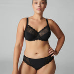 Model wearing Simone Pérèle Caresse Full Cup Bra in Black from The Foundation, featuring 3-part supportive cups, lace finish, and cotton lining. front view