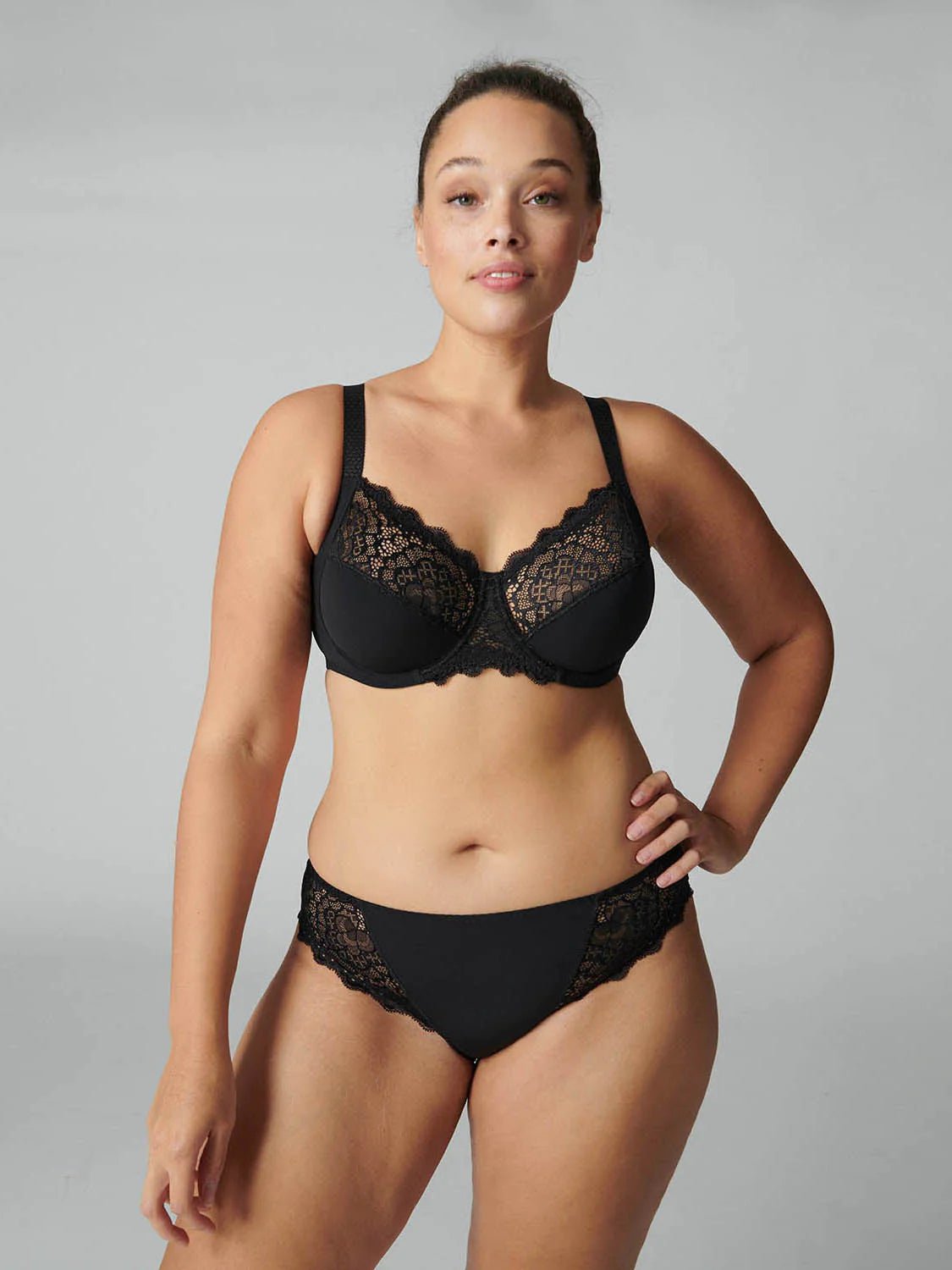 Model wearing Simone Pérèle Caresse Full Cup Bra in Black from The Foundation, featuring 3-part supportive cups, lace finish, and cotton lining. front view