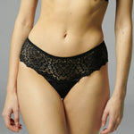 Simone Pérèle Caresse Shorty Brief in Black, worn by model, featuring low-rise silhouette with scalloped lace trim.