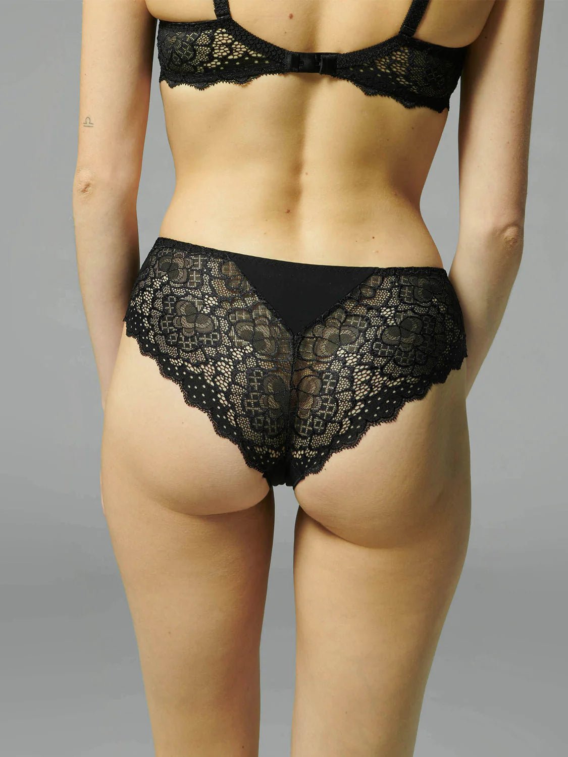 Back view of Caresse Shorty in Black, showcasing seamless microfibre finish and curve-hugging lace design.