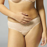 Simone Pérèle Caresse Shorty Brief in Peau Rose, shown on model with mid-rise lace design and scalloped leg trim.
