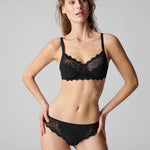Model wearing Simone Perele Caresse Soft Cup Bra in black—The Foundation