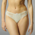 Model wearing Simone Perele Delice Bikini Brief in blush with stretch lace.