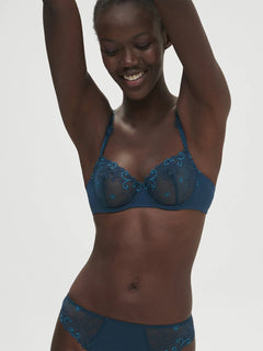 Model wearing Simone Perele Delice Half Cup Bra in Prestige Blue, sheer embroidered lace demi cup.