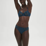 Simone Perele Delice Prestige Blue bra shown on model in joyful pose.