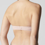 Back view of blush strapless bra by Simone Perele – smooth silhouette with adjustable, removable straps