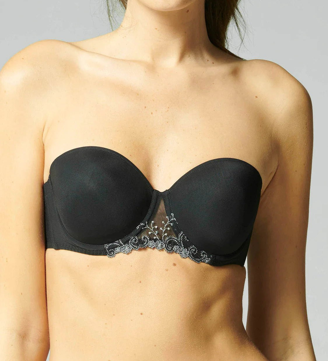 Model wearing Simone Pérèle Delice Strapless Bra in Moonlight from The Foundation, featuring smooth microfibre cups and embroidered tulle detailing. front view