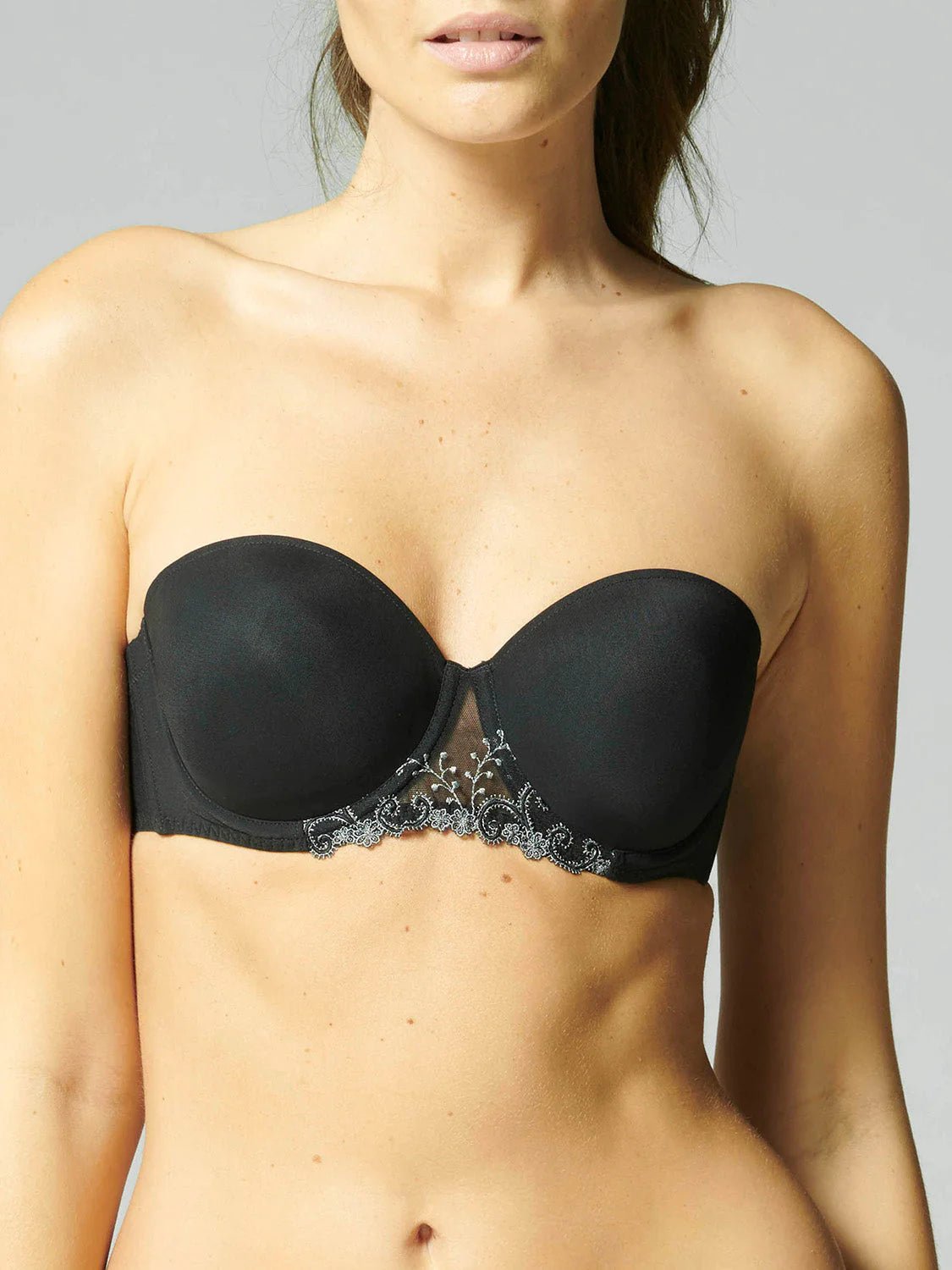 Model wearing Simone Pérèle Delice Strapless Bra in Moonlight from The Foundation, featuring smooth microfibre cups and embroidered tulle detailing. front view