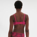 Back view of Intrigue Half Cup Bra Disco Pink by Simone Perele, highlighting band and fit details from The Foundation.