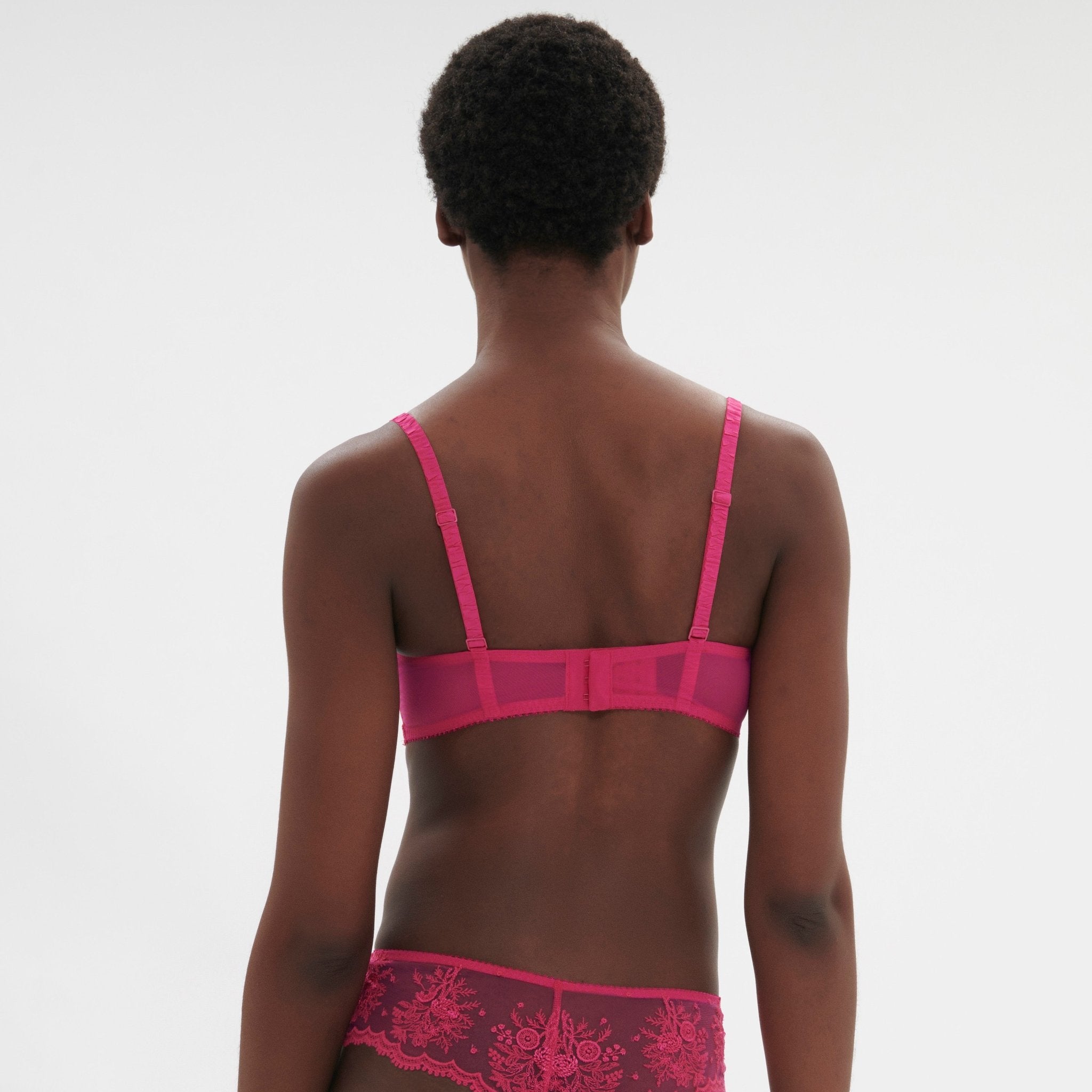 Back view of Intrigue Half Cup Bra Disco Pink by Simone Perele, highlighting band and fit details from The Foundation.