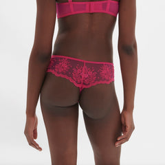 Back view of Intrigue Tanga Disco Pink by Simone Perele, showcasing sheer tulle and sexy cut from The Foundation.