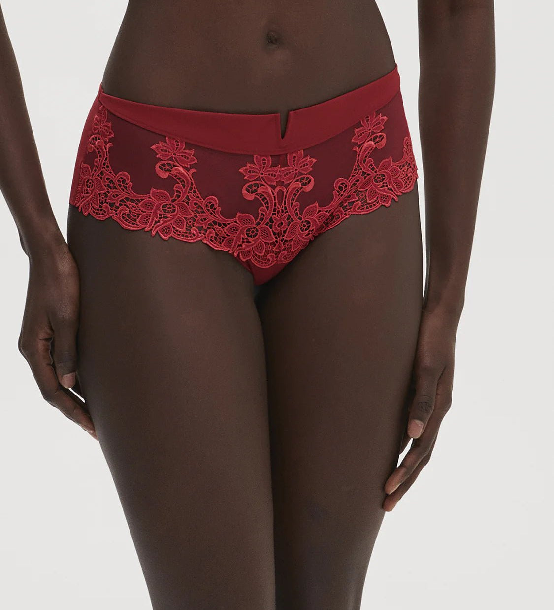 Front view of Saga Shorty Brief Lipstick by Simone Perele from The Foundation, showing rich red colour and detailed guipure lace