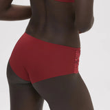 Side angle of model in Saga Shorty Brief Lipstick by Simone Perele from The Foundation, showing mid-rise fit and comfortable waistband