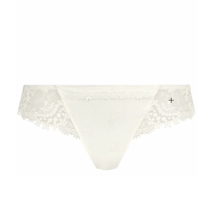 Flat lay of Simone Pérèle Wish Tanga brief in Natural, showing Brazilian-style back and delicate embroidered detail.