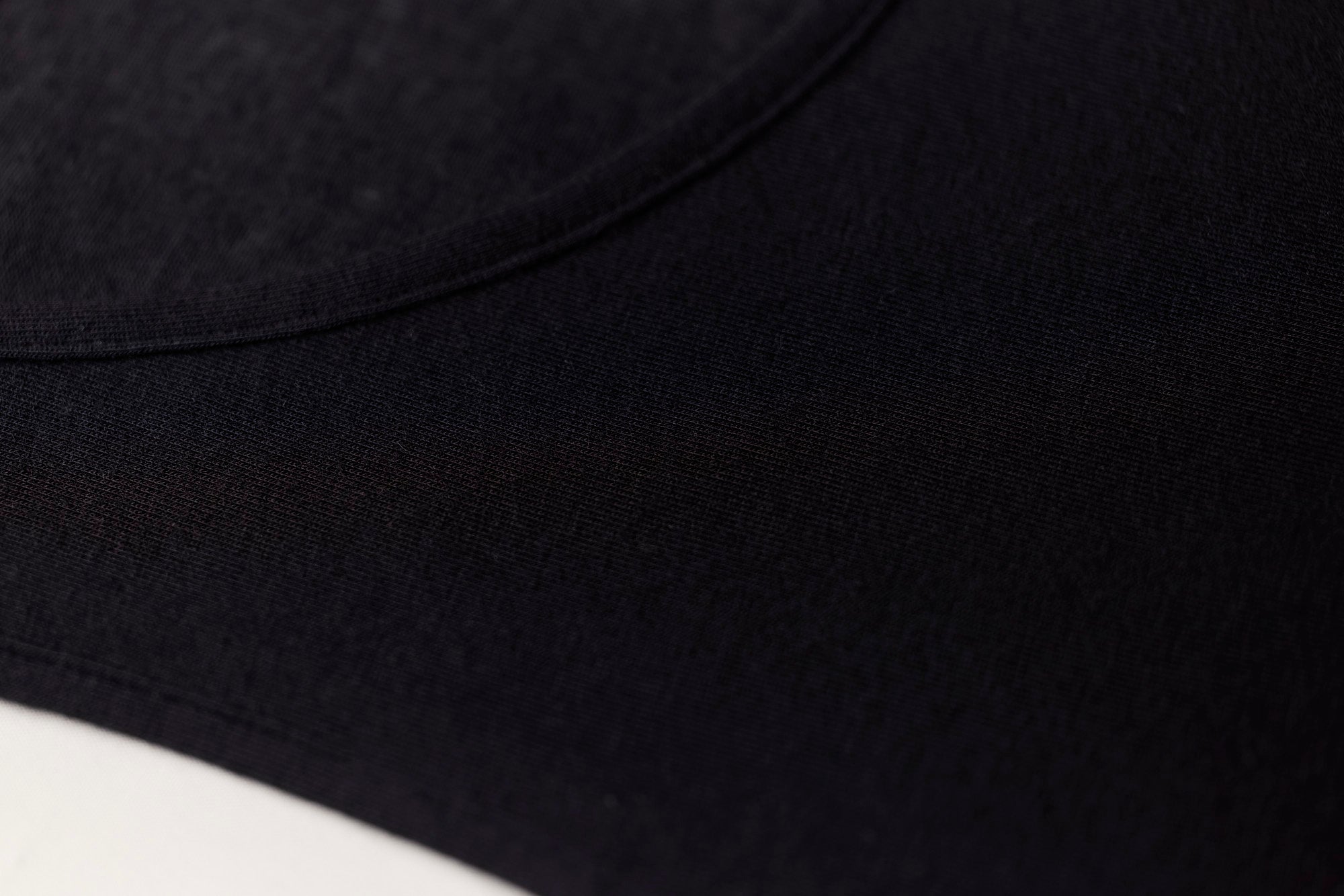TBL Modal Cashmere Long Sleeve Top in Black with scoop neckline and lightweight Italian-made thermal fabric – available at The Foundation (close up)